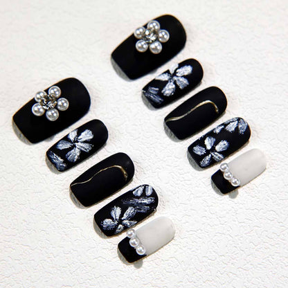 Elegant Black Nails with Pearl Embellishments