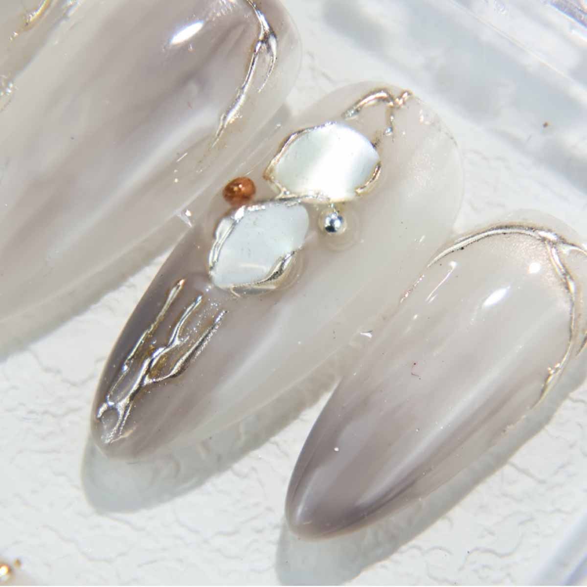 Elegant Marble Nails with Shell Accents