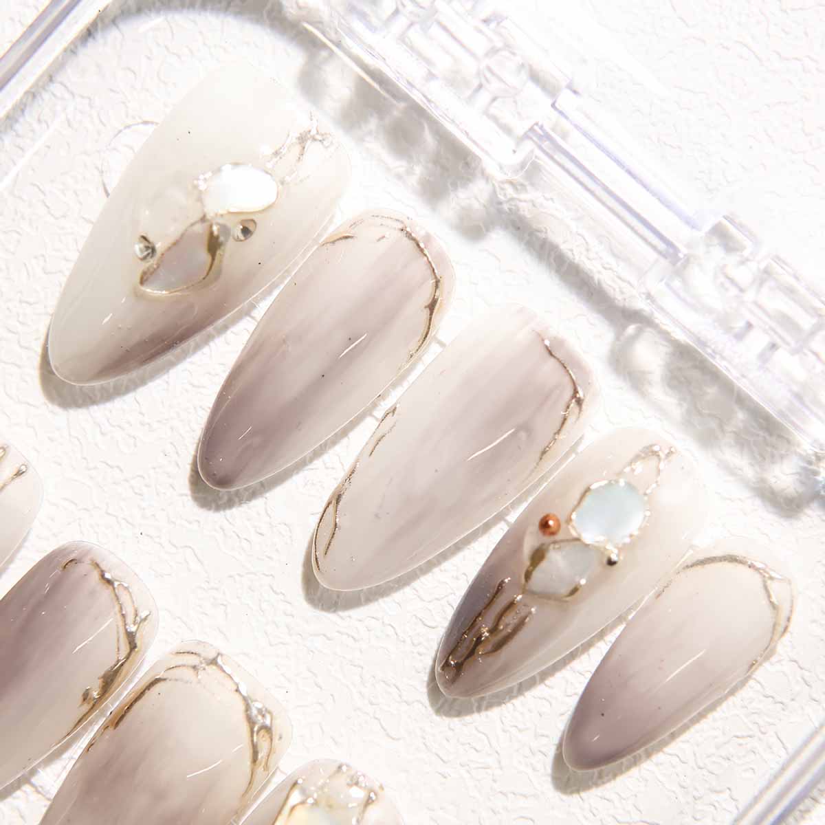 Elegant Marble Nails with Shell Embellishments