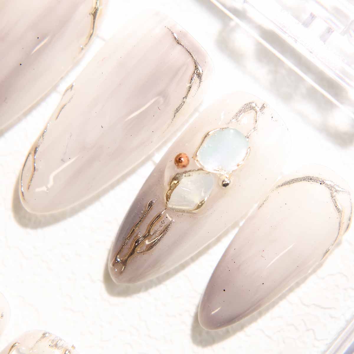 Elegant Marble Nails with Shell Embellishments